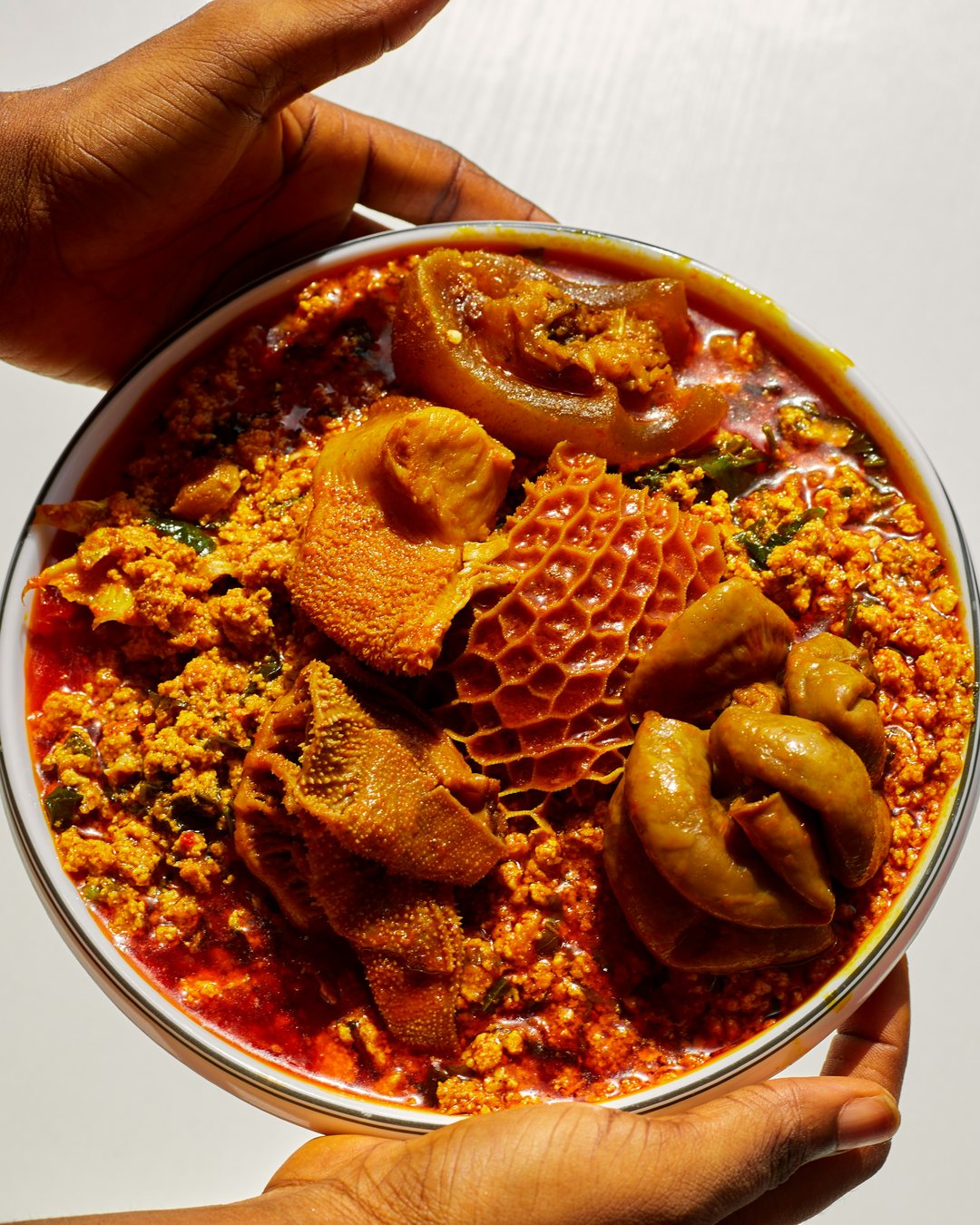 A bowl of egusi soup with assorted meat